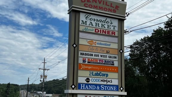 a sign for a market and diner on the side of a road