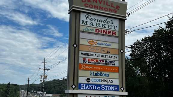 a sign for a market and diner on the side of a road