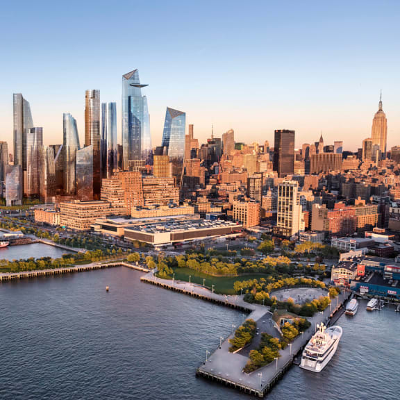 an aerial view of a city with tall buildings and a harbor in the foreground