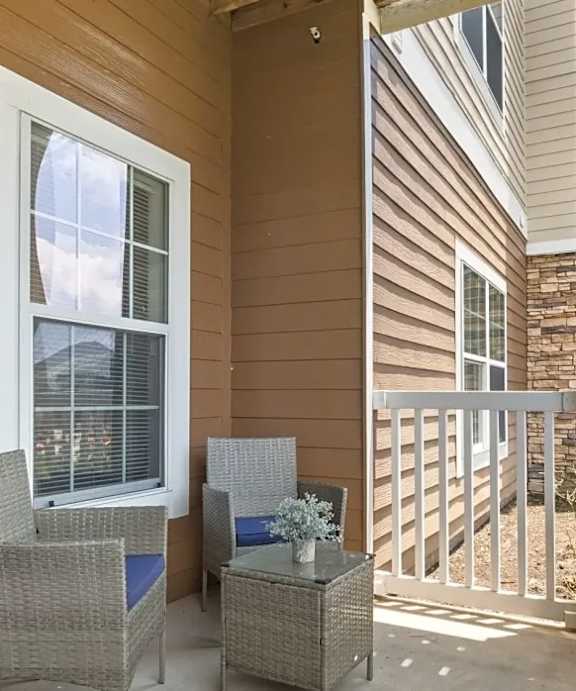 a balcony with a view of trees and a brick wall at Uphill Flats, Decatur, GA