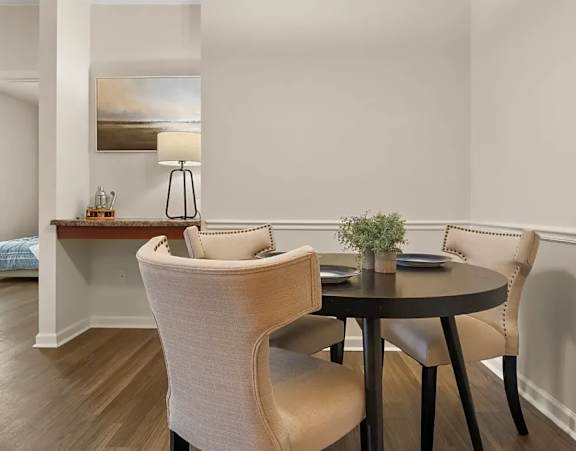 a living room with couches and chairs and a glass table at Uphill Flats, Decatur, GA, 30032