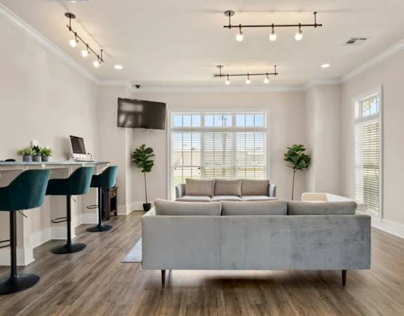 a renovated kitchen with white cabinets and black appliances at Uphill Flats, Decatur, GA