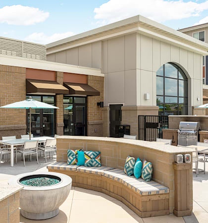 a patio with tables and chairs and a fire pit at Gabella at Parkside, Minnesota, 55124