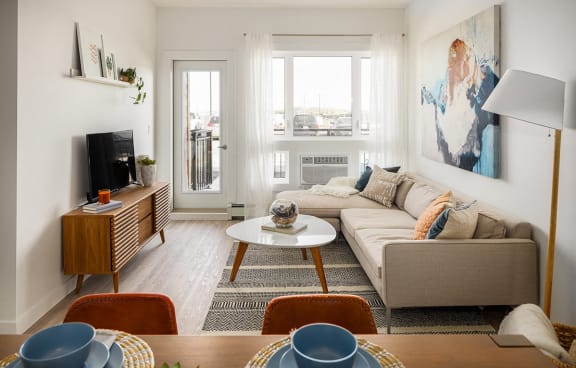 a living room with a couch and a table and a television