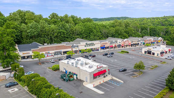 an aerial view of a shopping mall with a parking lot