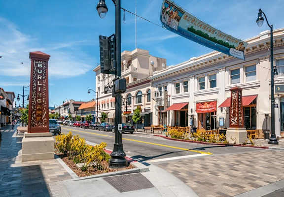 A street view of a sunny day with a clear blue sky.