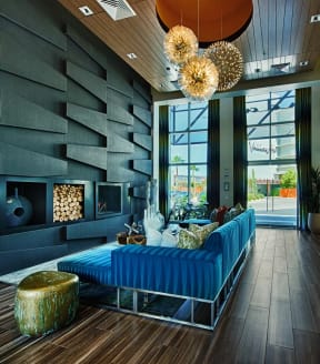 a lobby with a blue couch and wood floors
