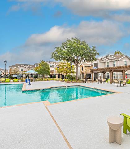 our apartments have a resort style pool with lounge chairs at Rosemont at Mayfield Villas, Arlington, Texas