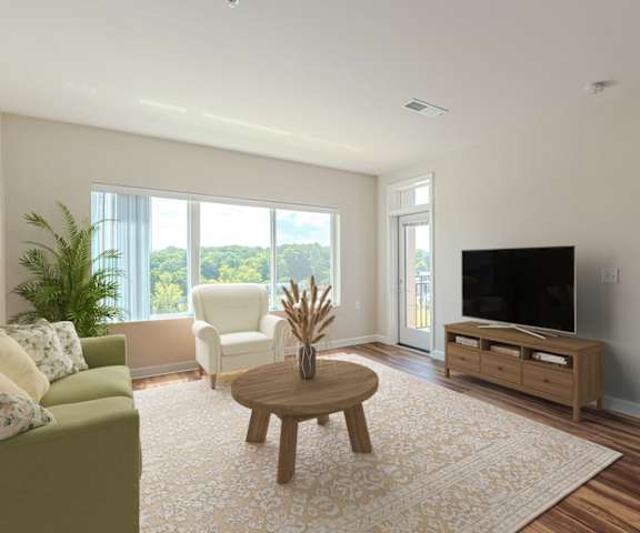 a living room with a couch and a table and a tv at Briar Park 55+ Apartments, Atlanta