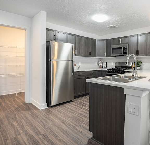 a kitchen with a breakfast bar and huge pantry at Meadowbrooke Apartment Homes, Grand Rapids, MI