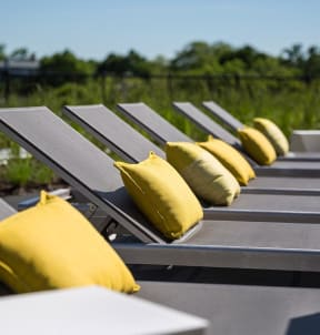 a row of benches with pillows on them