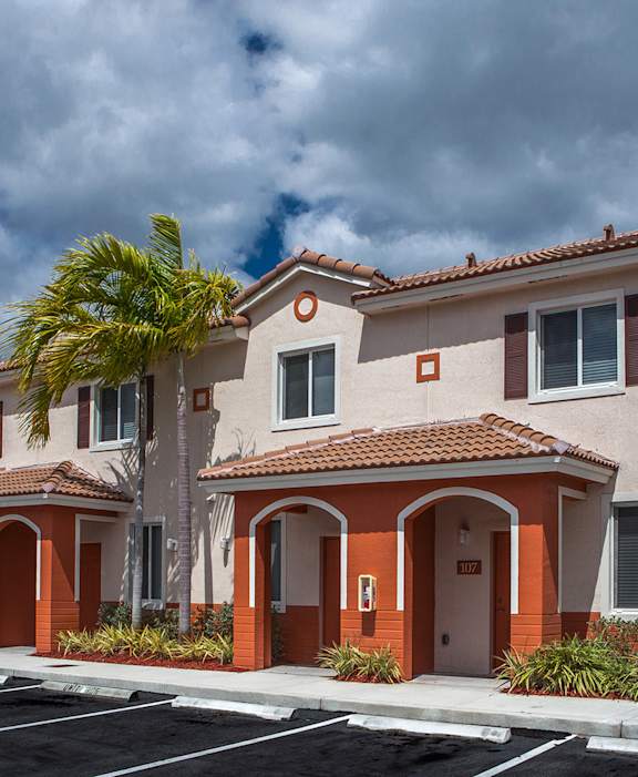 A row of houses with orange trim and brown roofs.