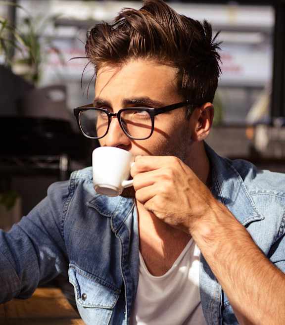 A man in a denim jacket and glasses is drinking from a white cup.at Montage, Oregon
