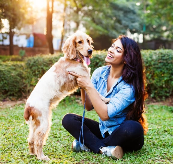 a woman sitting on the grass with her dog at 1305 Dock Street, Maryland