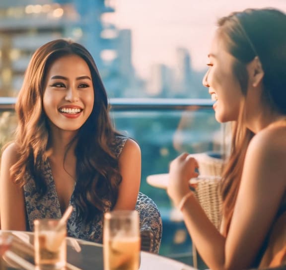 two women sitting at a table in a restaurant