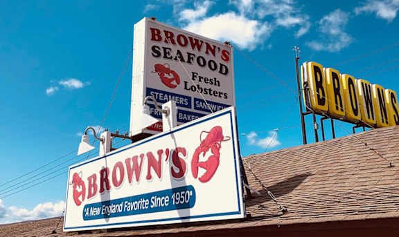 A restaurant sign for Brown's Seafood is displayed on a building.