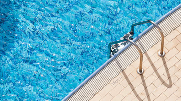a swimming pool with a ladder on the side of it