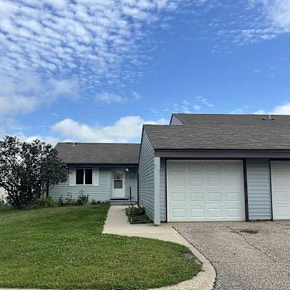 a blue house with a white garage door