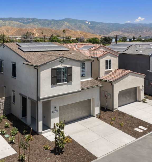 A house with a garage and solar panels on the roof.