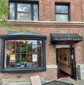 A brick building with a sign that says "Collegetown Bagels".