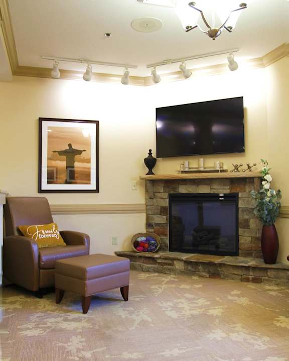 A living room with a fireplace and a television.