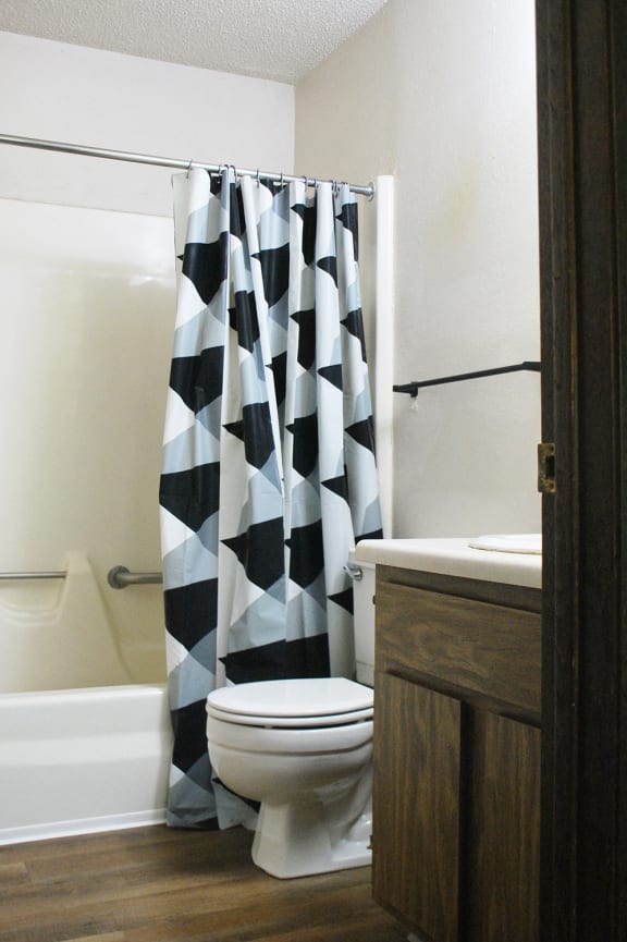a bathroom with a toilet and a sink and a bath tub