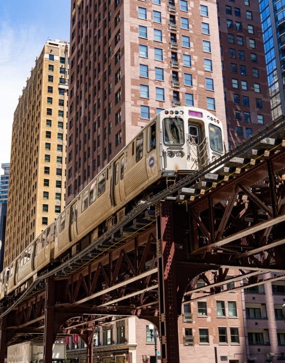 a train going over a bridge in a city