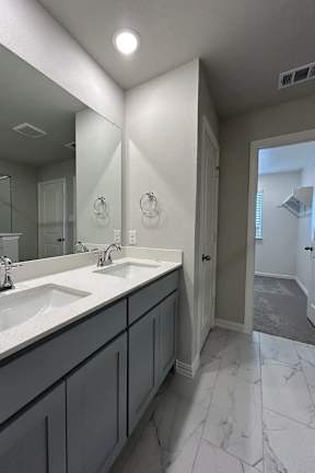 A Bathroom With a Marble Floor at Cottages at Beltmill Apartments, Saginaw