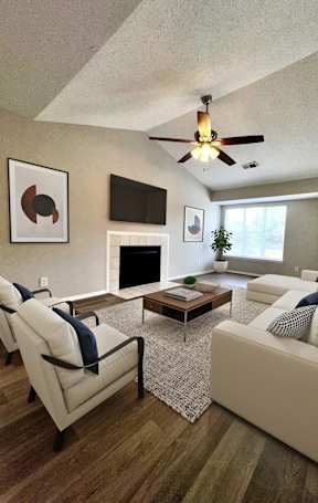 A living room with a white couch and a coffee table.