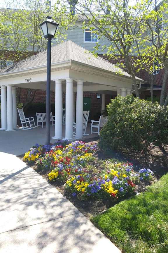 A patio with a chair and a small table.