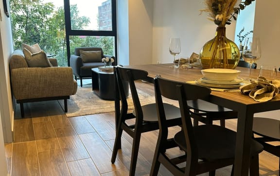 a dining room and living room with a table and chairs