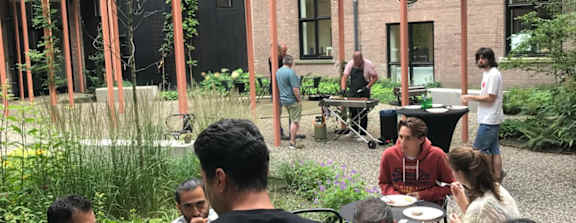 A group of people are sitting around a table eating food.