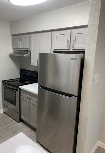 A kitchen with a stainless steel refrigerator and oven at Brook Meadow Village Apartments , Austin, TX, 78758