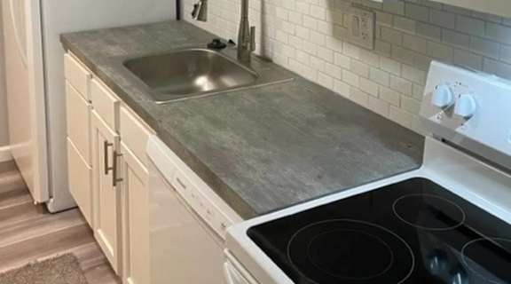 a kitchen with white cabinets and a sink