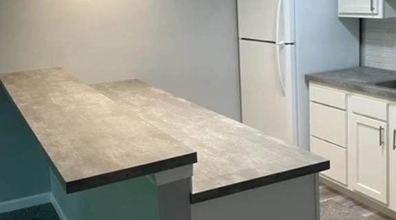a kitchen with a counter top and a refrigerator