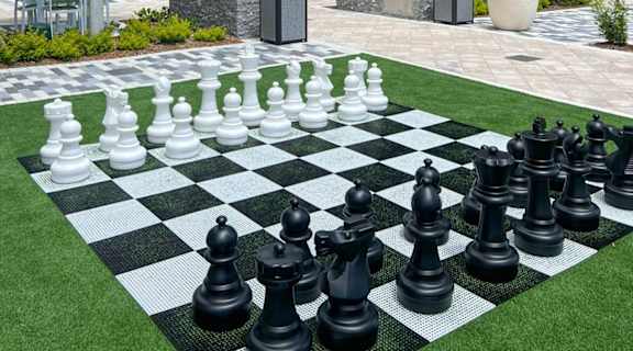 a giant chess board in front of an apartment building