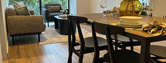 a dining room and living room with a table and chairs