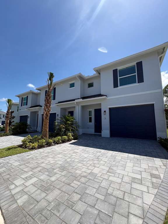 A modern house with a driveway in front.