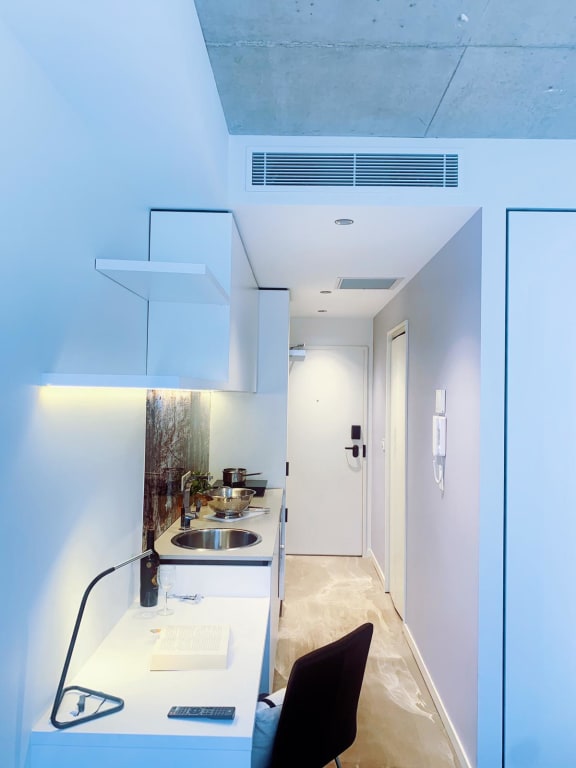 a kitchen with a white counter top and a sink