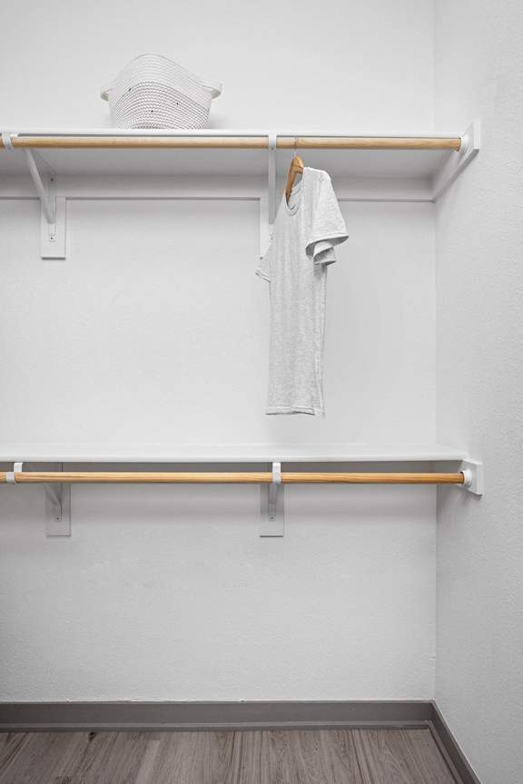 a white t-shirt hanging on a rack in a white room at Slate at Fishers District, Indiana