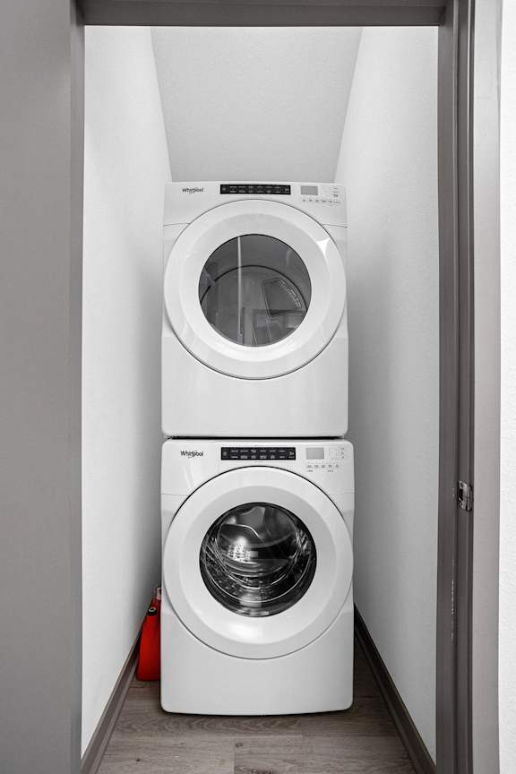 a white washer and dryer in a small laundry room  at Slate at Fishers District, Fishers, Indiana