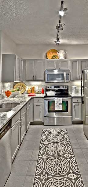 A modern kitchen with a patterned tile floor.