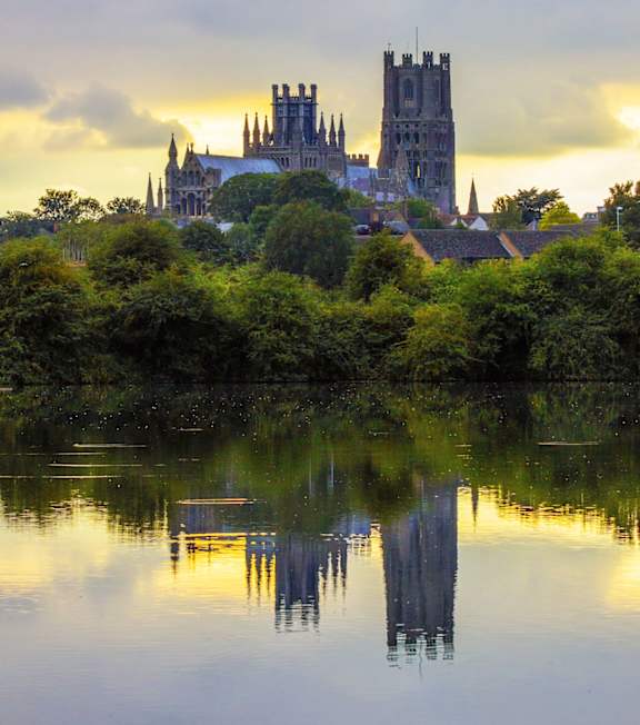 Castle is reflected in the water at The Chapters , Ely, CB7 4DI