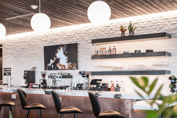 a bar with bar stools and a counter in a restaurant
