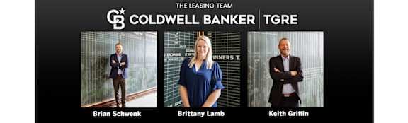 Three people are standing in front of a sign that says Coldwell Banker Tgere.