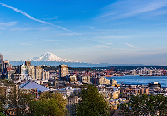 a view of the seattle skyline with mount rainier in the background