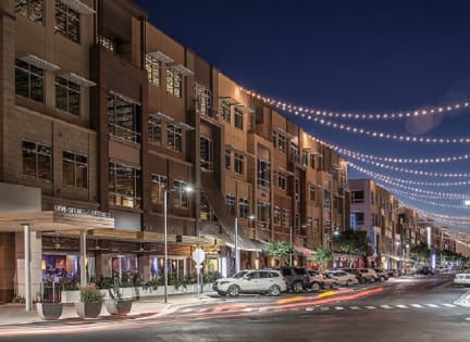 a city street at night with lights strung across the street at 56 North, Phoenix, 85054