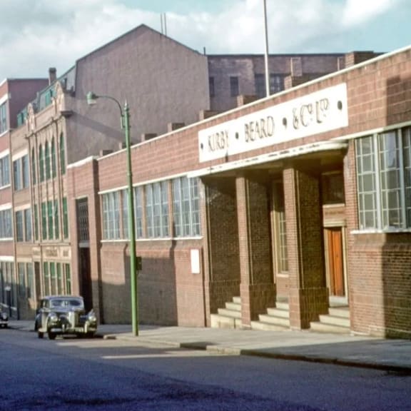 an old photo of a building on a city street