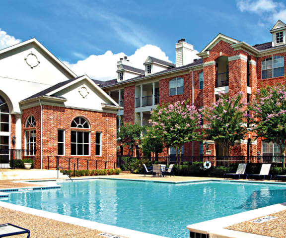 img src="swimming pool.png" alt=courtyard with swimming pool & lounge chairs outside brick building"