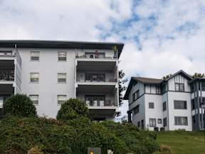 A large white building with a balcony on the second floor.at Maplehurst Apartments, Tennessee, 37902